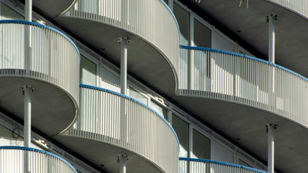 Close-up view of a modern building showcasing curved balconies with a unique architectural design.